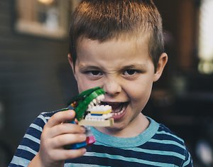 Home. boy with croc and angry face